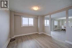 Laminate wood-finish flooring throughout, complemented by a neutral color palette - 