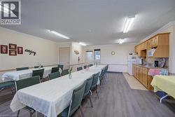 Spacious common area featuring wood-finish flooring, recessed lighting, and a full kitchen - 