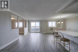 Spacious interior featuring wood-finish flooring, light gray wall tones, and crown molding throughout - 