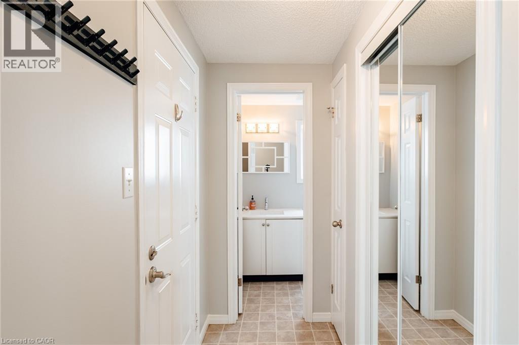 Inviting entryway featuring tile flooring and a bright, neutral color palette - 560 Penny Lane, Waterloo, ON