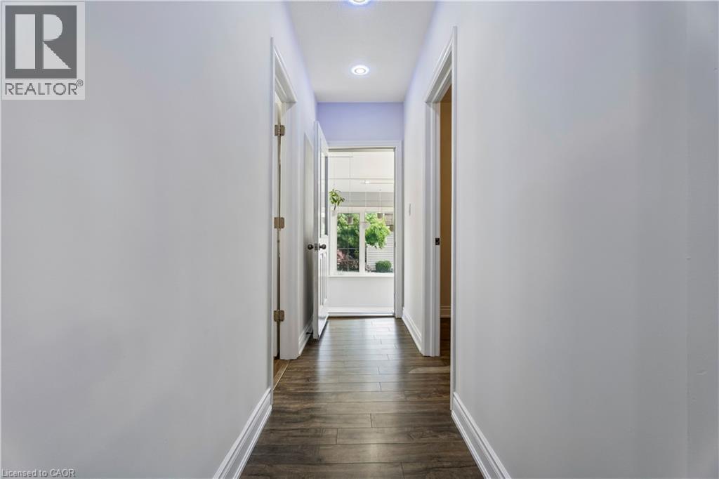 Hallway featuring wood-finish flooring, light-colored walls, recessed lighting, and white baseboards - 180 Campbell Avenue, Hamilton, ON - Indoor Photo Showing Other Room