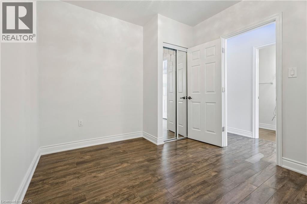 Interior room featuring wood-finish flooring, white baseboards, and neutral wall paint - 180 Campbell Avenue, Hamilton, ON - Indoor Photo Showing Other Room