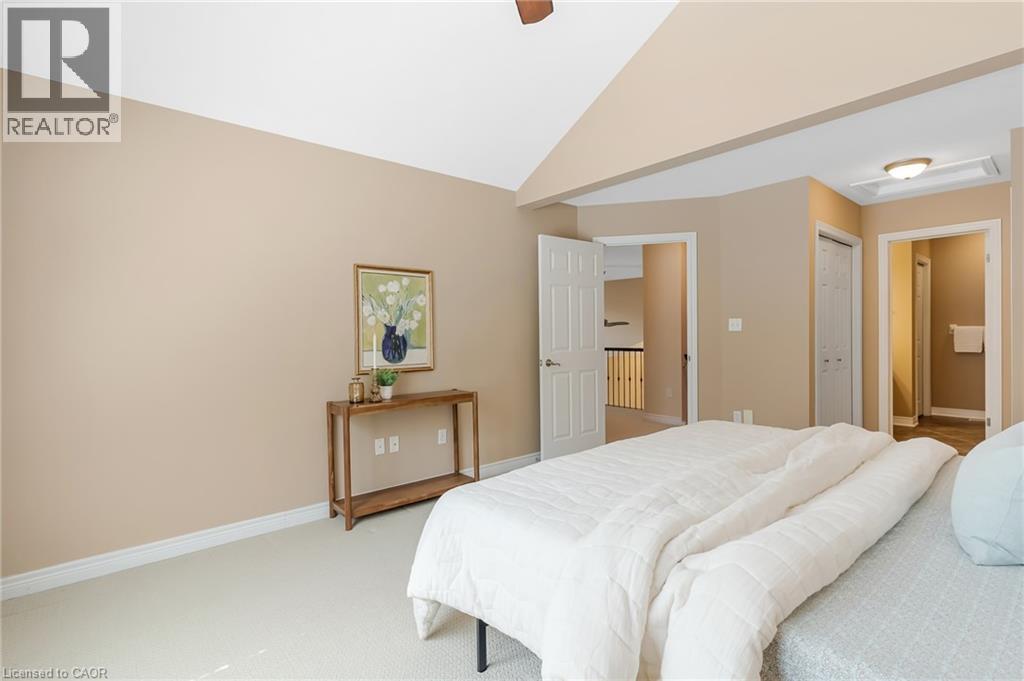 Carpeted bedroom featuring vaulted ceilings, neutral wall tones, and white trim - 227 Chestnut Hill Crescent, Kitchener, ON - Indoor Photo Showing Bedroom