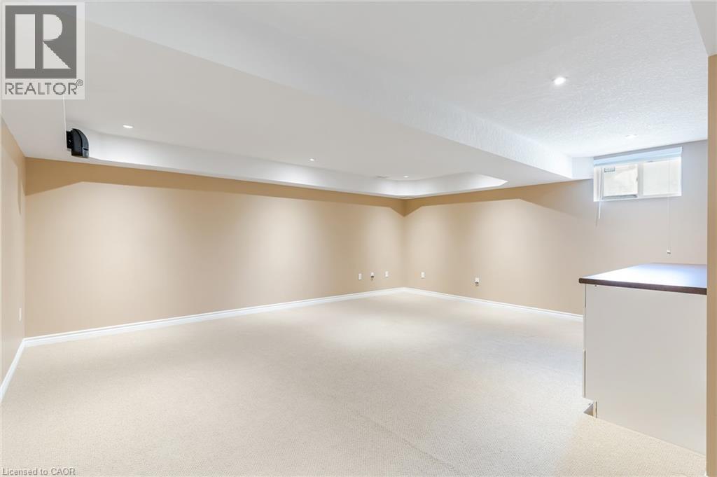 Spacious room featuring neutral carpeting, recessed ceiling lighting, and a built-in counter - 227 Chestnut Hill Crescent, Kitchener, ON - Indoor Photo Showing Other Room
