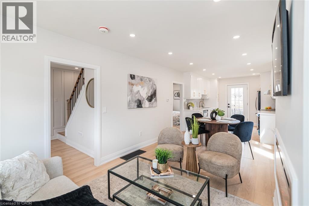 Bright open-concept living area with light wood-finish flooring - 297 Britannia Avenue, Hamilton, ON