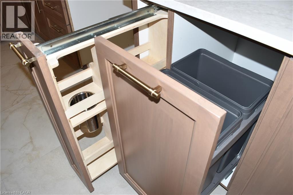 Integrated pull-out storage solutions featuring light wood-finish cabinetry, brushed brass hardware - 8 Dunlop Road, Hamilton, ON - Indoor Photo Showing Kitchen