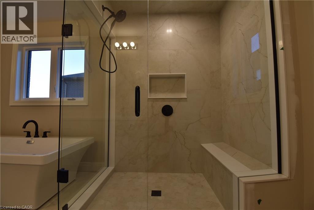 Spa-inspired primary bathroom featuring a spacious walk-in shower with frameless glass enclosure, rainfall showerhead, and integrated body spray jets - 8 Dunlop Road, Hamilton, ON - Indoor Photo Showing Bathroom