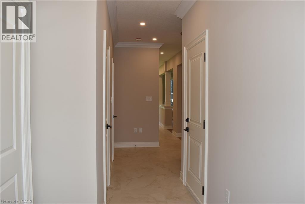 Hallway with recessed lighting, crown molding, and paneled doors with dark hardware - 8 Dunlop Road, Hamilton, ON - Indoor Photo Showing Other Room