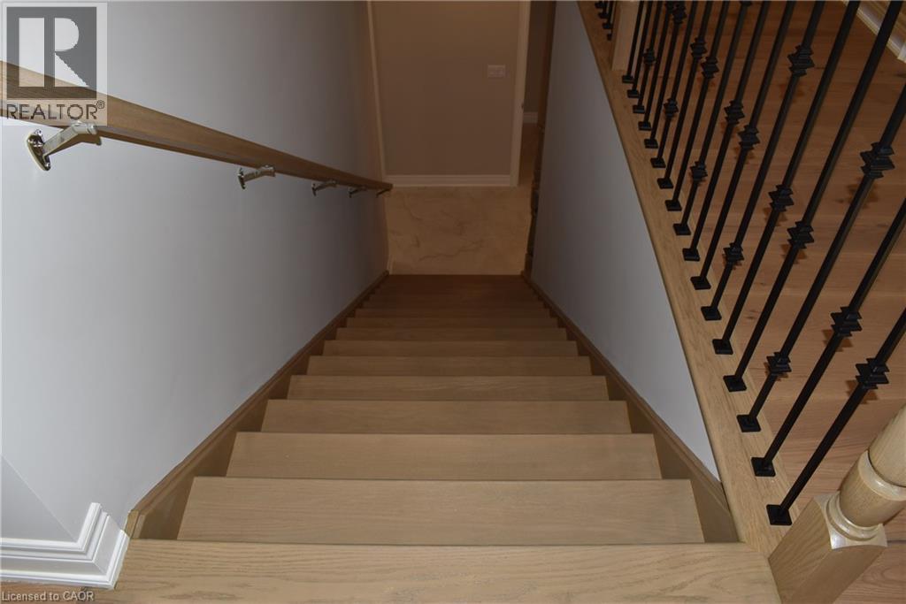 Hardwood staircase featuring light-toned wood-finish treads and risers - 8 Dunlop Road, Hamilton, ON - Indoor Photo Showing Other Room