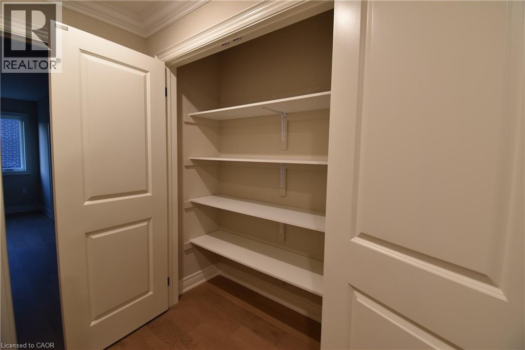 Built-in shelving with wood-finish flooring and crown molding - 8 Dunlop Road, Hamilton, ON - Indoor