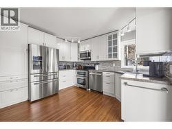 Updated kitchen with stainless steel appliances and granite counters -