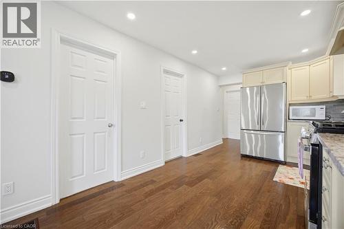Warm wood-finish flooring extending through the space - 71 Beland Avenue N, Hamilton, ON 