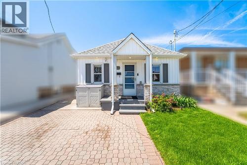 White siding exterior with stone veneer accents - 71 Beland Avenue N, Hamilton, ON 