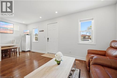 Bright interior space featuring wood-finish flooring, recessed lighting, and white walls - 71 Beland Avenue N, Hamilton, ON 