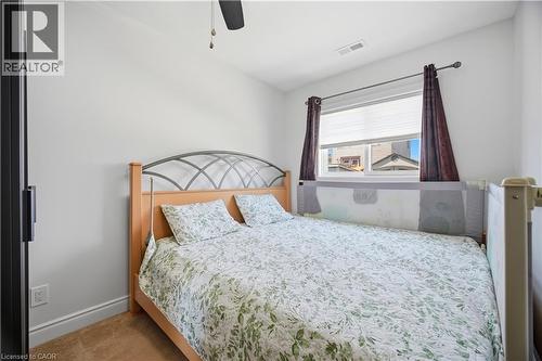 Bright room featuring a window with white blinds, neutral wall paint, and carpet flooring - 71 Beland Avenue N, Hamilton, ON 