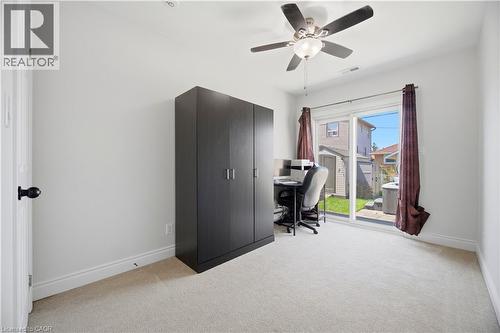 Room featuring light-colored carpeting, white walls, and a ceiling fan with integrated lighting - 71 Beland Avenue N, Hamilton, ON 