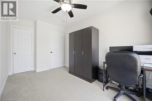 Neutral toned room featuring light-colored carpeting, white walls, and a ceiling fan with integrated lighting - 71 Beland Avenue N, Hamilton, ON 