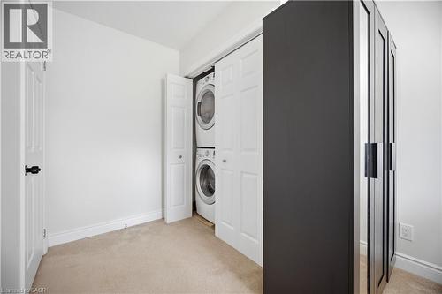 Dedicated laundry closet featuring a stacked washer and dryer - 71 Beland Avenue N, Hamilton, ON 