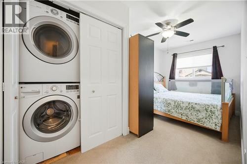 Dedicated laundry closet featuring a stacked washer and dryer - 71 Beland Avenue N, Hamilton, ON 
