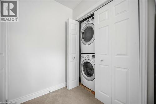 Integrated laundry closet featuring a stacked washer and dryer - 71 Beland Avenue N, Hamilton, ON 