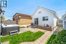 Expansive backyard featuring a hot tub, patio space, and a manicured lawn - 71 Beland Avenue N, Hamilton, ON 