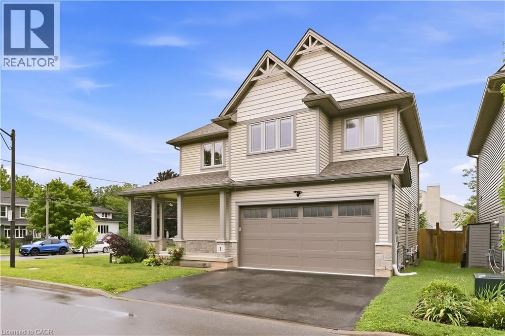 Contemporary two-story residence featuring light-colored siding, a covered front porch, and an integrated garage - 1 Lindsay Way, Grimsby, ON - Outdoor