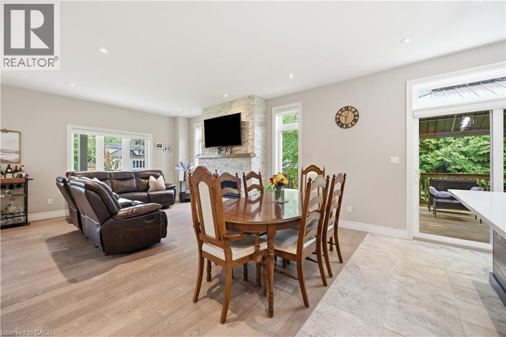 Open-concept interior featuring recessed lighting, a stone-clad fireplace, and expansive windows - 1 Lindsay Way, Grimsby, ON - Indoor