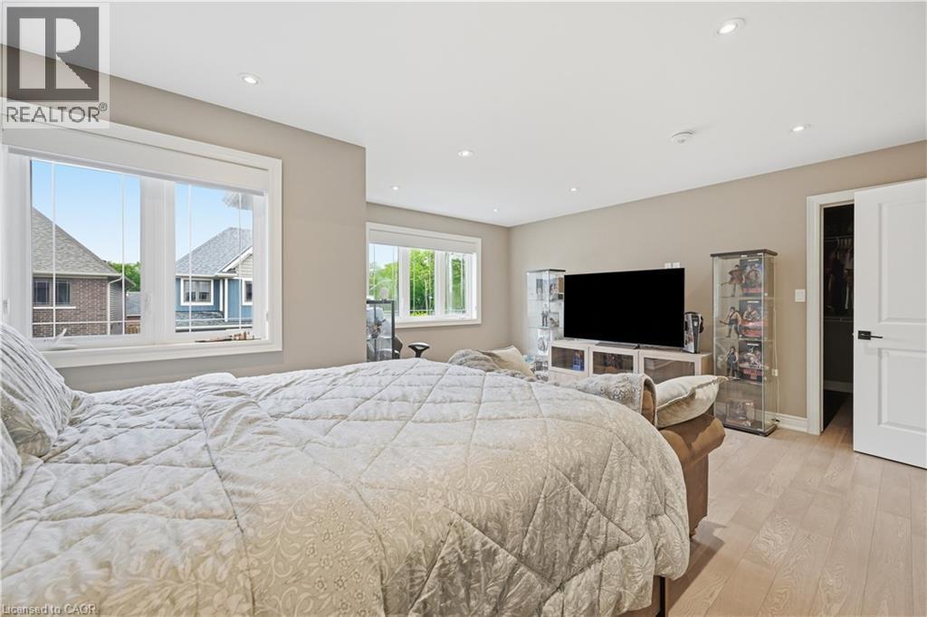 Spacious room featuring multiple windows, recessed lighting, light wood-finish flooring, and a white paneled door - 1 Lindsay Way, Grimsby, ON - Indoor Photo Showing Bedroom