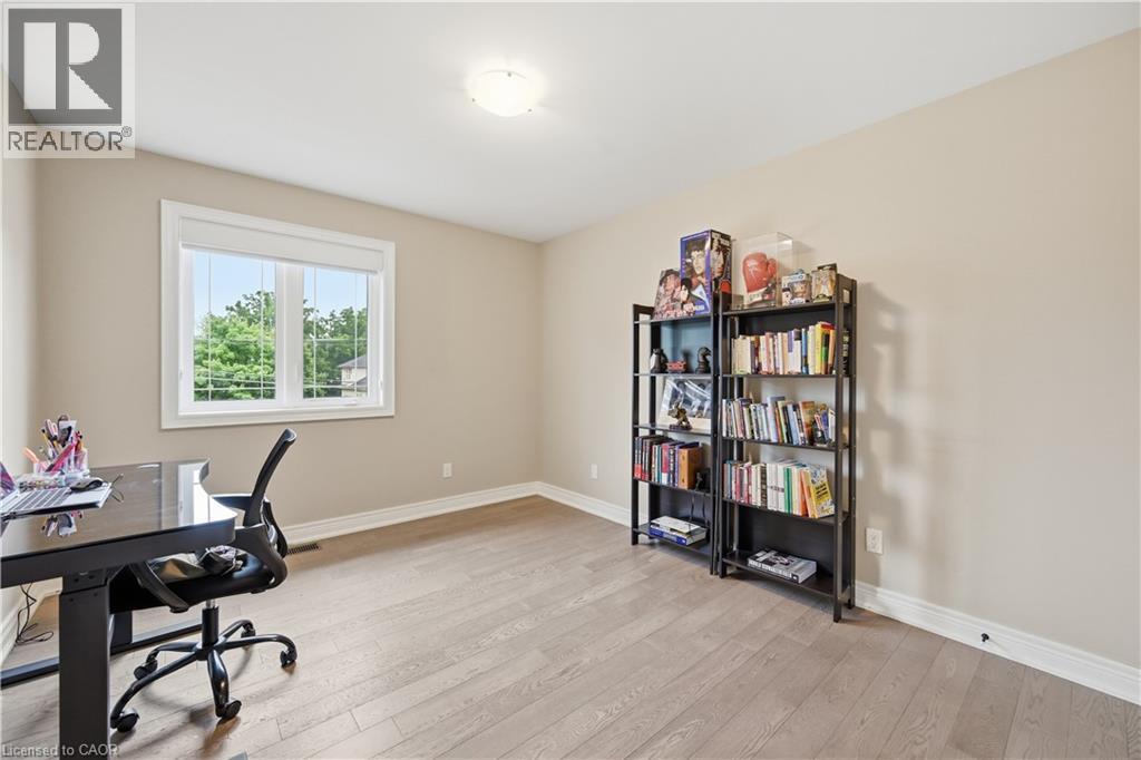 Bright room featuring light wood-finish flooring, neutral-toned walls, a single window with white trim, and a flush-mount ceiling light - 1 Lindsay Way, Grimsby, ON - Indoor Photo Showing Office