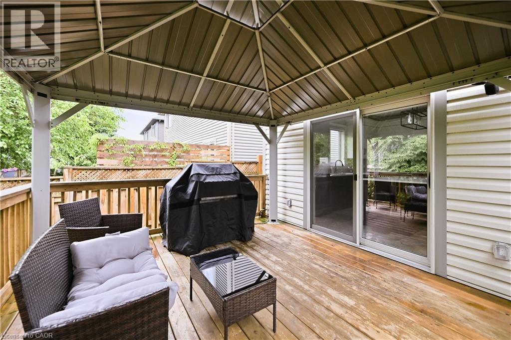 Deck with a permanent metal gazebo, wood railing, and sliding glass door - 1 Lindsay Way, Grimsby, ON - Outdoor With Deck Patio Veranda With Exterior