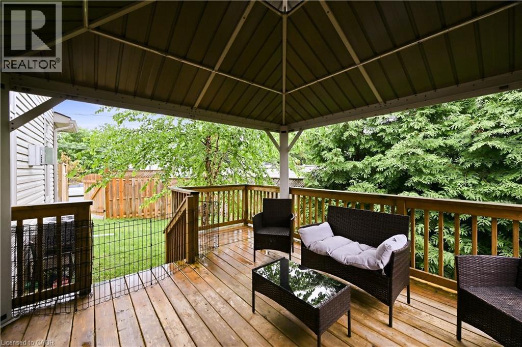 Expansive wood-finish deck featuring a metal-frame gazebo, wood railing, and stairs descending to a fenced yard - 1 Lindsay Way, Grimsby, ON - Outdoor With Deck Patio Veranda With Exterior