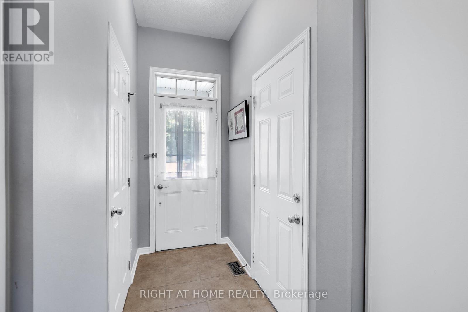 Front Entrance with Garage and Partial Bath - 577 Ashbourne Crescent, Ottawa, ON