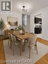 Bright dining area featuring wood-finish flooring, a contemporary chandelier, and an opening to the kitchen - 396 Pinemeadow Avenue, Mississauga, ON