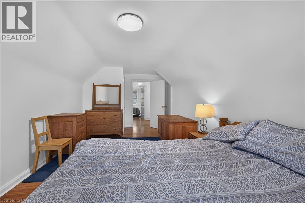 Bedroom featuring sloped ceilings and hardwood flooring - 83 Aberfoyle Avenue, Hamilton, ON