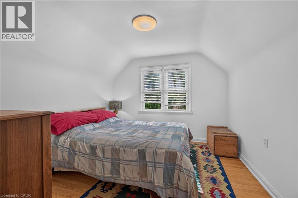 Hardwood flooring in a room with white walls and a sloped ceiling - 83 Aberfoyle Avenue, Hamilton, ON