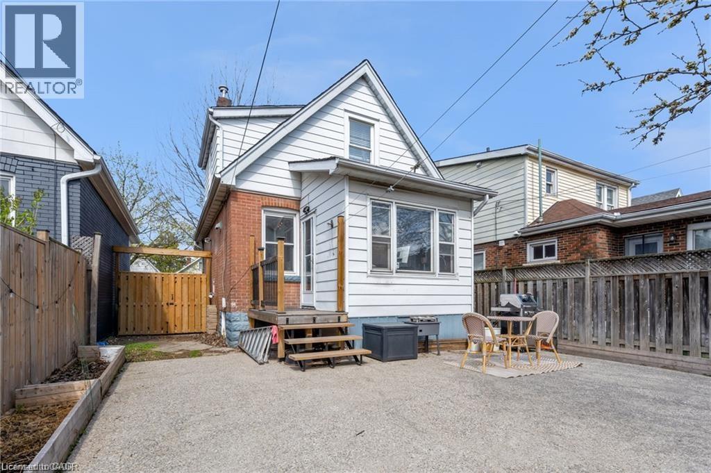Gravel surfaced yard with perimeter fencing - 22 Cope Street, Hamilton, ON