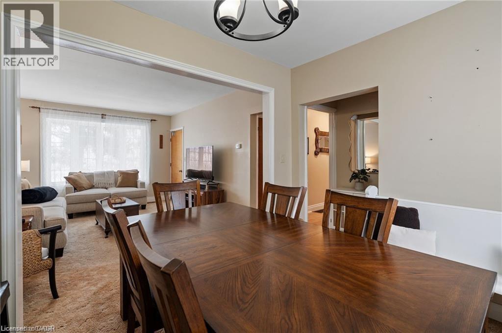 Formal dining area featuring wood-finish flooring, a contemporary ceiling light fixture, and an open entryway to an additional living space - 2 Mill Street E, York, ON