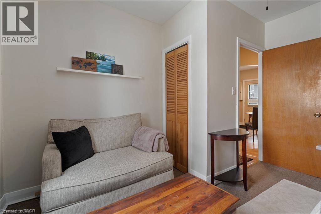 Interior space featuring a white floating shelf, neutral wall tones, and a wooden bi-fold closet door - 2 Mill Street E, York, ON