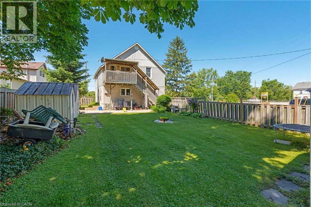 Expansive green lawn with a perimeter wood fence - 2 Mill Street E, York, ON