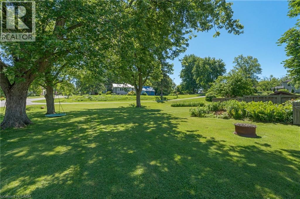 Expansive lawn with mature shade trees and a dedicated garden area - 2 Mill Street E, York, ON