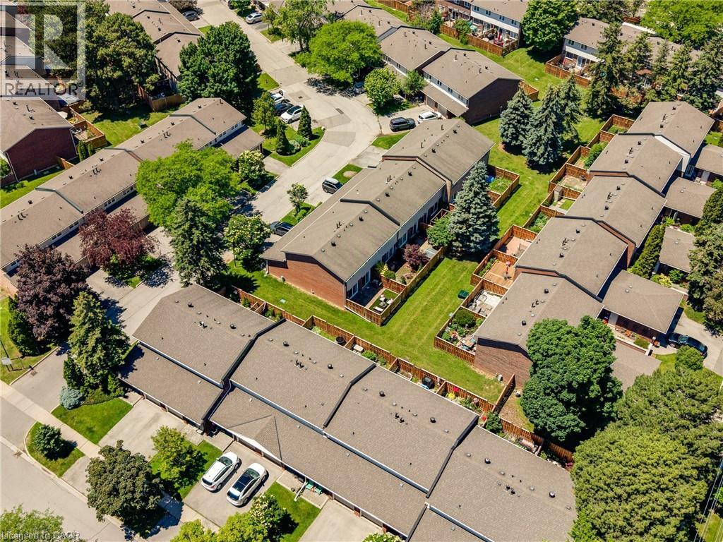Aerial perspective showcasing a residential community with numerous townhome-style properties - 5275 Banting Court, Burlington, ON