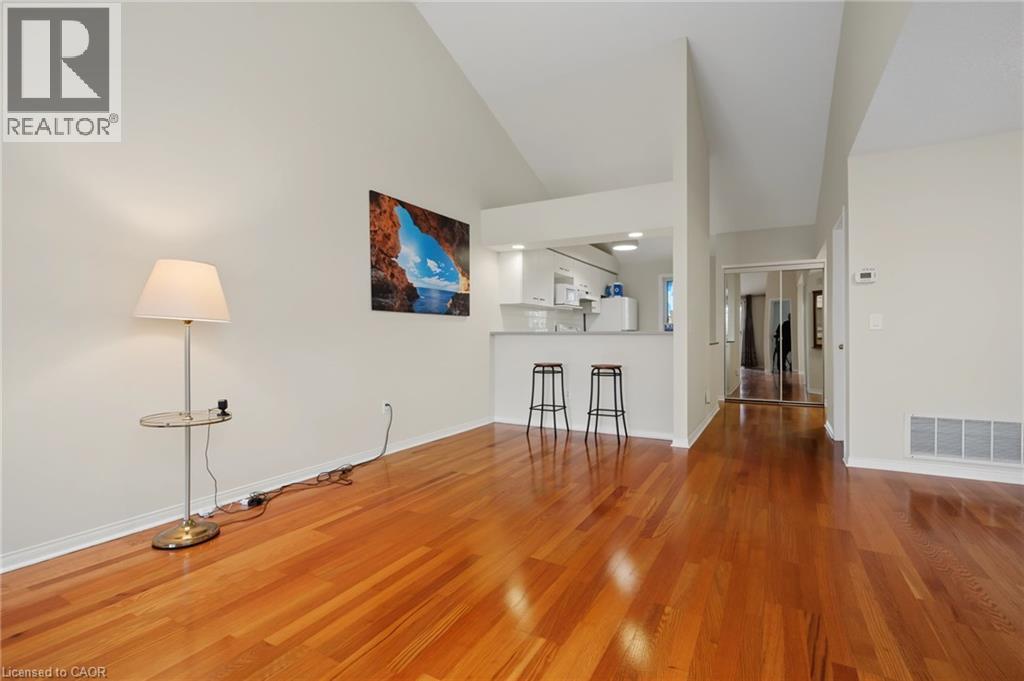 Varnished wood-finish flooring throughout the main living area - 117 E Bristol Road E Unit# 64, Mississauga, ON
