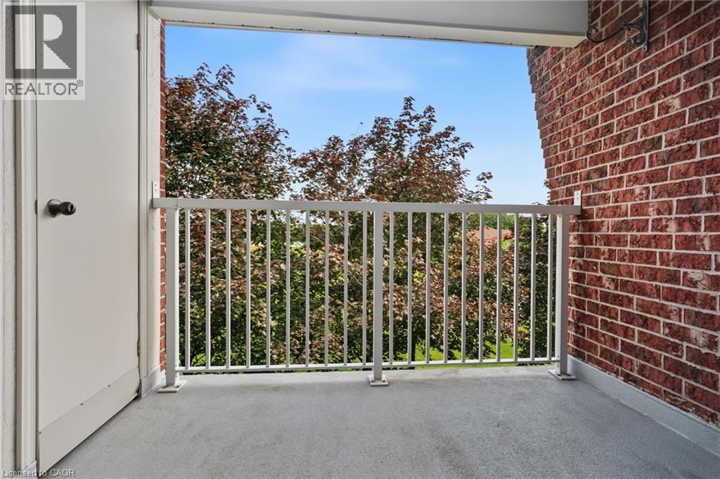 Balcony featuring a concrete surface, white metal railing, and a red brick exterior wall - 117 E Bristol Road E Unit# 64, Mississauga, ON