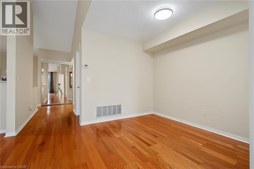 Room featuring wood-finish flooring, neutral wall tones, and recessed lighting - 117 E Bristol Road E Unit# 64, Mississauga, ON
