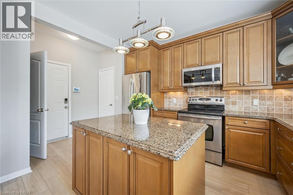 Kitchen with access to garage, basement and coat/broom closet for extra storage - 79 Zieman Crescent, Cambridge, ON