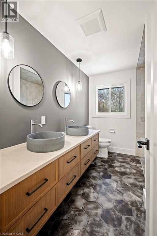 Dual vessel sinks with wall-mounted faucets - 361 Coleridge Place, Waterloo, ON - Indoor Photo Showing Bathroom