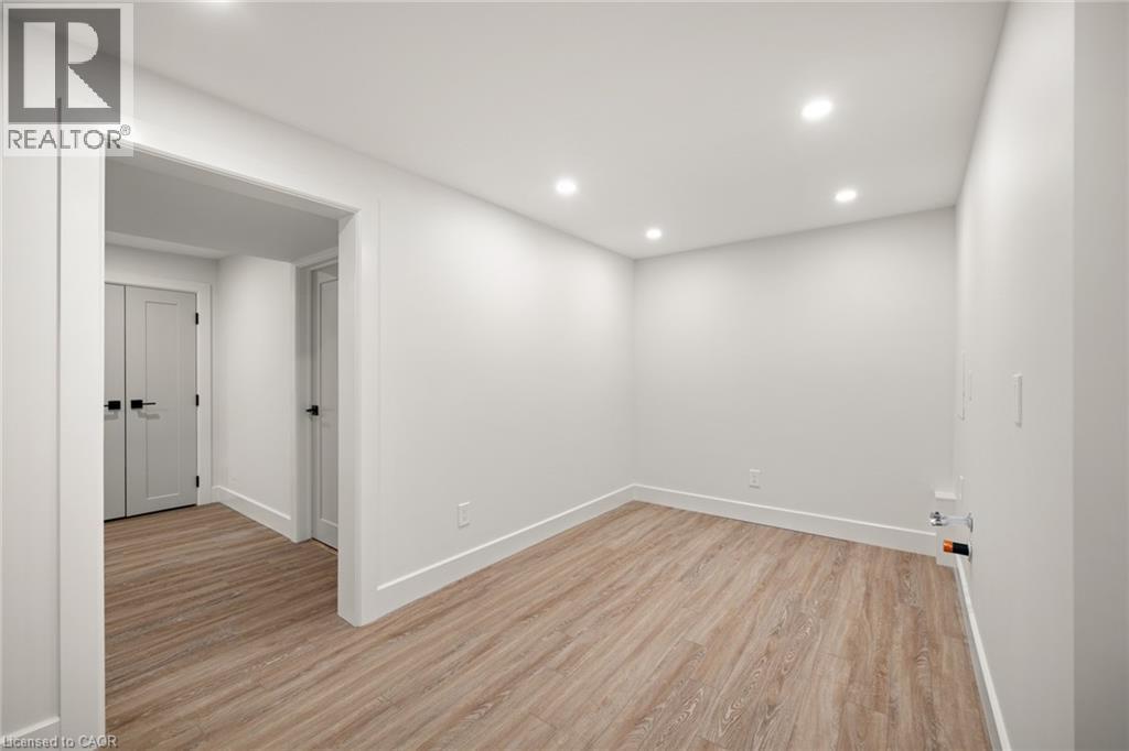Bright room featuring wood-finish flooring, recessed lighting, and crisp white walls - 361 Coleridge Place, Waterloo, ON - Indoor Photo Showing Other Room