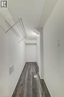 Walk-in closet with wood-finish flooring, white walls, and wire shelving system -