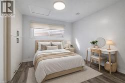 Bright room featuring wood-finish flooring and built-in cabinetry with matte black hardware -