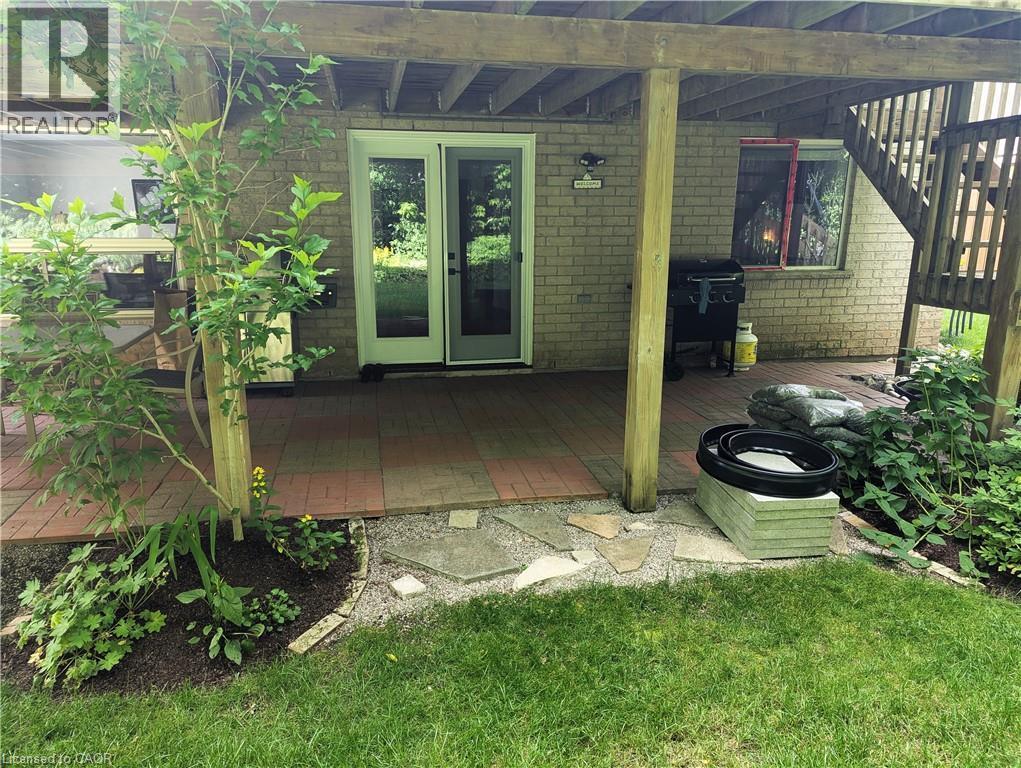 Entrance to the apartment with outdoor patio and BBQ - 561 Marl Meadow Crescent Unit# Lower, Kitchener, ON